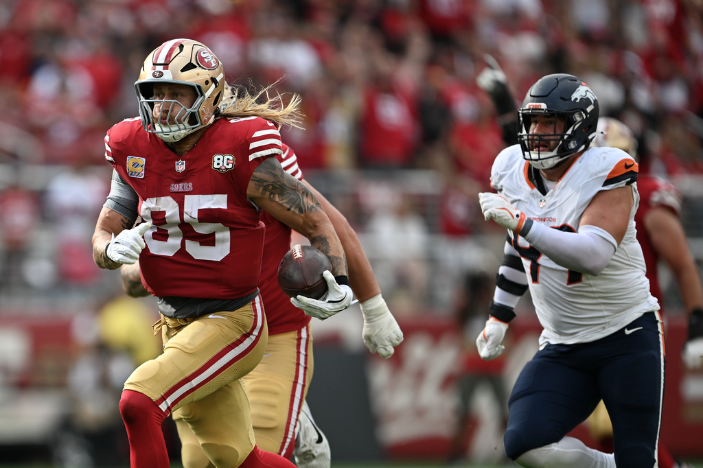 San Francisco 49ers tight end George Kittle (85) runs past Denver Broncos defensive end Zach Allen to score during the second half of an NFL football game in Santa Clara, Calif., Sunday, Oct. 4, 2026. (AP Photo/Justine Willard)