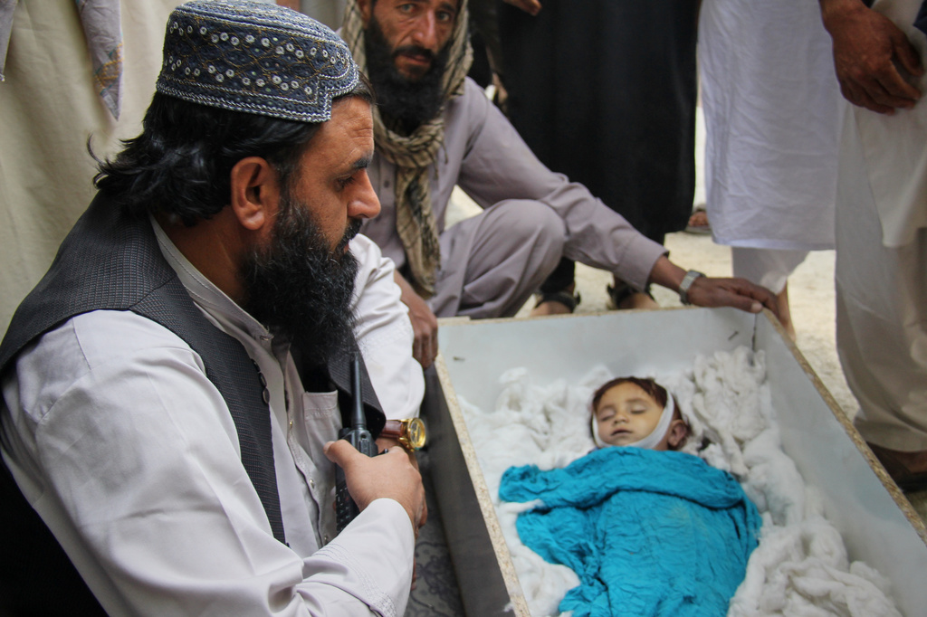 Residents mourn over the body of a child killed in airstrikes that Taliban officials said were carried out by Pakistan and killed civilians, including children, in Mana, a village in Afghanistan's Khost province, Wednesday, June 10, 2026. (AP Photo/Saifullah Zahir)