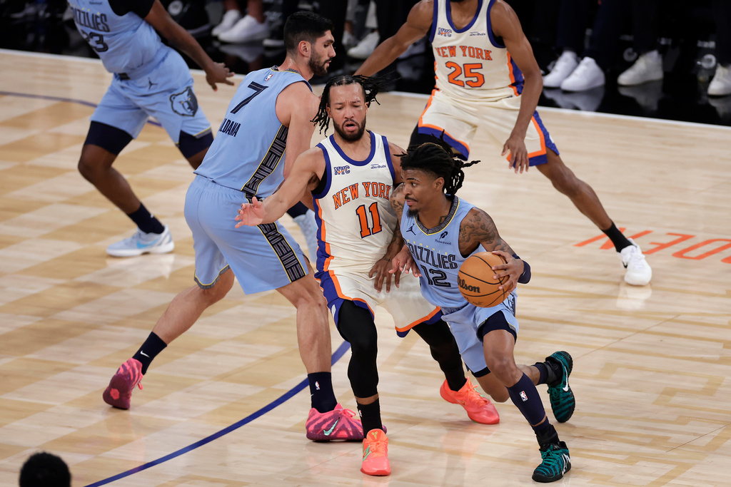 Memphis Grizzlies guard Ja Morant (12) drives past New York Knicks guard Jalen Brunson (11) during the first half of an NBA basketball game, Tuesday, Nov. 11, 2025, in New York. (AP Photo/Adam Hunger)