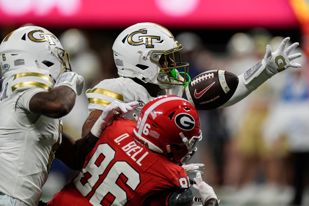 Georgia Tech defensive back Rodney Shelley (6) breaks up a pass intended for Georgia wide receiver Dillon Bell (86) during the first half of an NCAA college football game, Friday, Nov. 28, 2025, in Atlanta. (AP Photo/Mike Stewart)