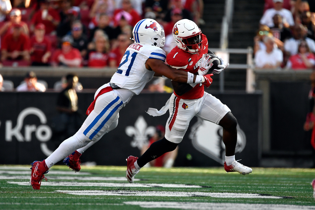 SMU safety Jimmy Wyrick (21) tackles Louisville running back Isaac Brown (1) during the second half of an NCAA college football game in Louisville, Ky., Saturday, Sept. 19, 2026. (AP Photo/Timothy D. Easley)
