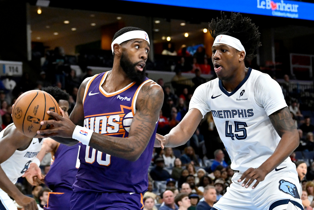 Phoenix Suns forward Royce O'Neale (00) handles the ball against Memphis Grizzlies forward GG Jackson (45) in the first half of an NBA basketball game Wednesday, Jan. 7, 2026, in Memphis, Tenn. (AP Photo/Brandon Dill)