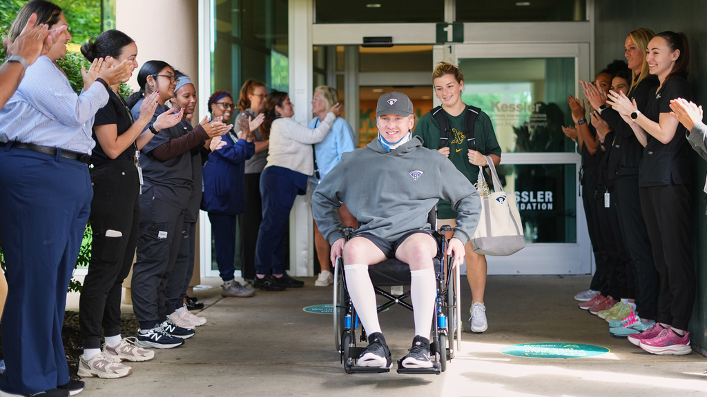 Caregivers clap out Ryan Lasko, a minor league prospect with the Athletics who was paralyzed in an outfield collision more than two months ago, upon his discharge from Kessler Institute for Rehabilitation in West Orange, N.J., Wednesday, Sept. 16, 2026. (AP Photo/Matt Rourke)
