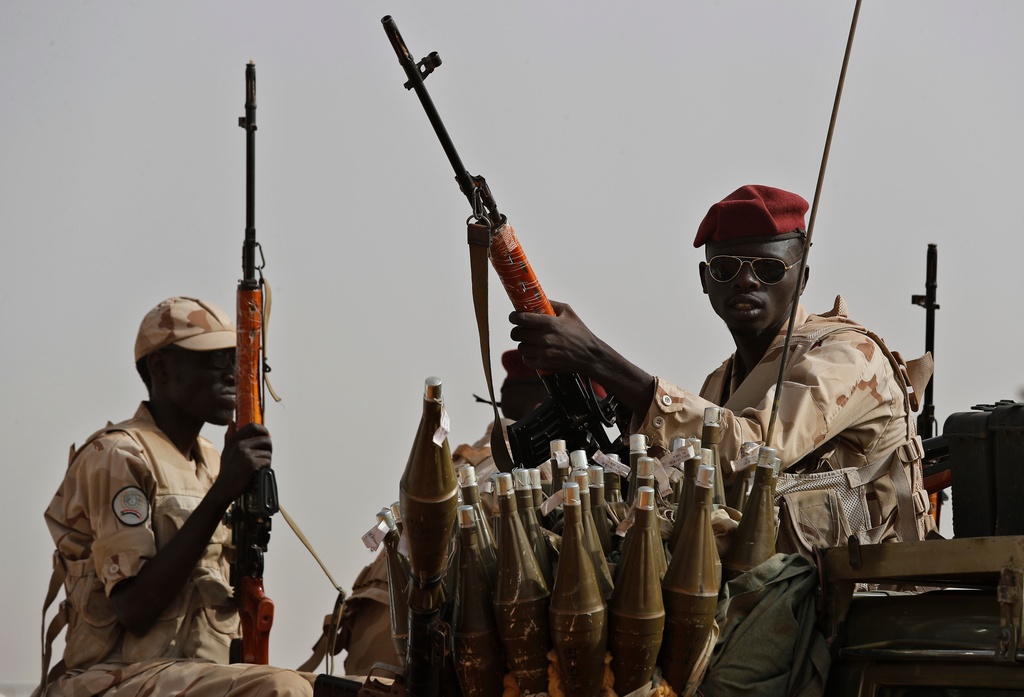 FILE - Sudanese soldiers from the Rapid Support Forces unit, led by Gen. Mohammed Hamdan Dagalo, the deputy head of the military council, secure the area where Dagalo attends a military-backed tribe's rally, in the East Nile province, Sudan, June 22, 2019. (AP Photo/Hussein Malla, File)