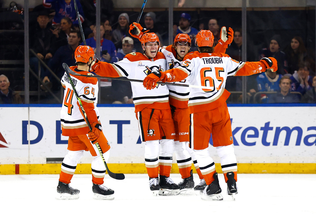 Anaheim Ducks defenseman Jackson Lacombe (2) celebrates with teammates after scoring during the second period of an NHL hockey game against the New York Rangers, Monday, Dec 15, 2025, in New York. (AP Photo/Noah K. Murray)