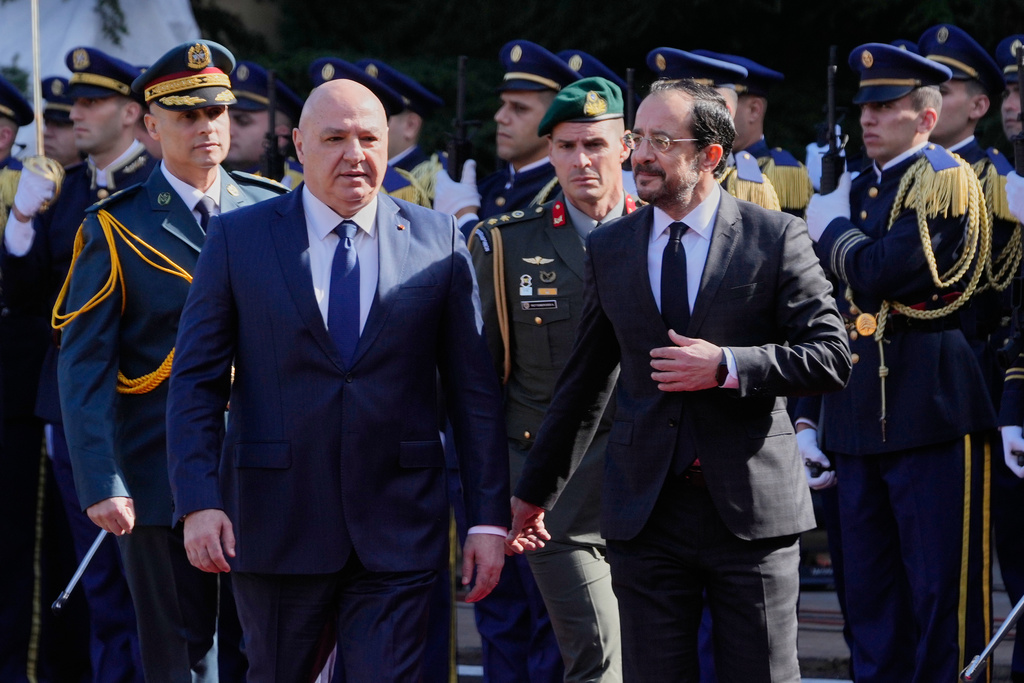 Lebanese President Joseph Aoun, left, walks with Cypriot President Nikos Christodoulides during an official welcoming ceremony at the Presidential Palace in Baabda, east of Beirut, Lebanon, Wednesday, Nov. 26, 2025. (AP Photo/Hussein Malla)