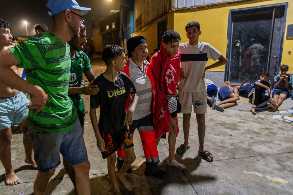 Unaccompanied minors who crossed into Spain from Morocco spend the night on the streets in the Spanish enclave of Ceuta, Friday, July 31, 2026. (AP Photo/Antonio Sempere)