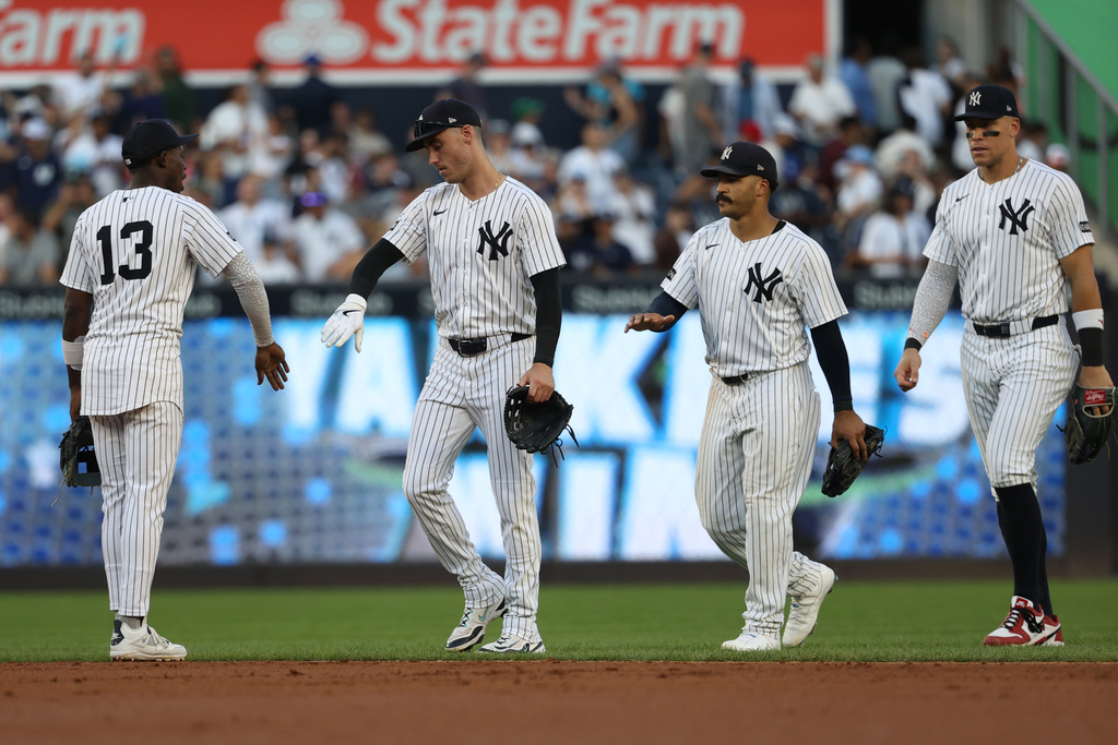 From left to right, New York Yankees' Jazz Chisholm Jr., Cody Bellinger, Trent Grisham and Aaron Judge react after defeating the Baltimore Orioles in a baseball game Sunday, Sept. 28, 2025, in New York. (AP Photo/Pamela Smith)