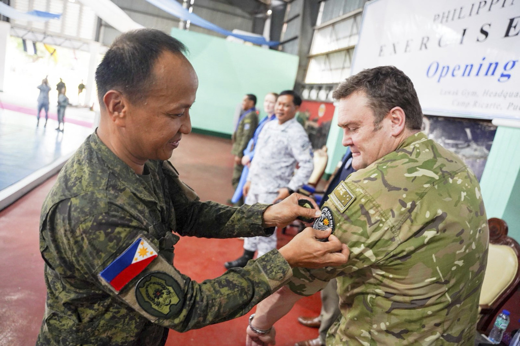 In this photo provided by the Armed Forces of the Philippines, Maj. Gen. Francisco F Lorenzo Jr., left, commander of the AFP Education, Training and Doctrine Command, pins the ALON Exercise 2025 patch on Deputy Chief of Joint Operations Maj. Gen. Hugh McAslan during the opening ceremony of joint military drills between Australia and the Philippines in Palawan province, Philippines on Friday, Aug. 15, 2025. (Armed Forces of the Philippines via AP)