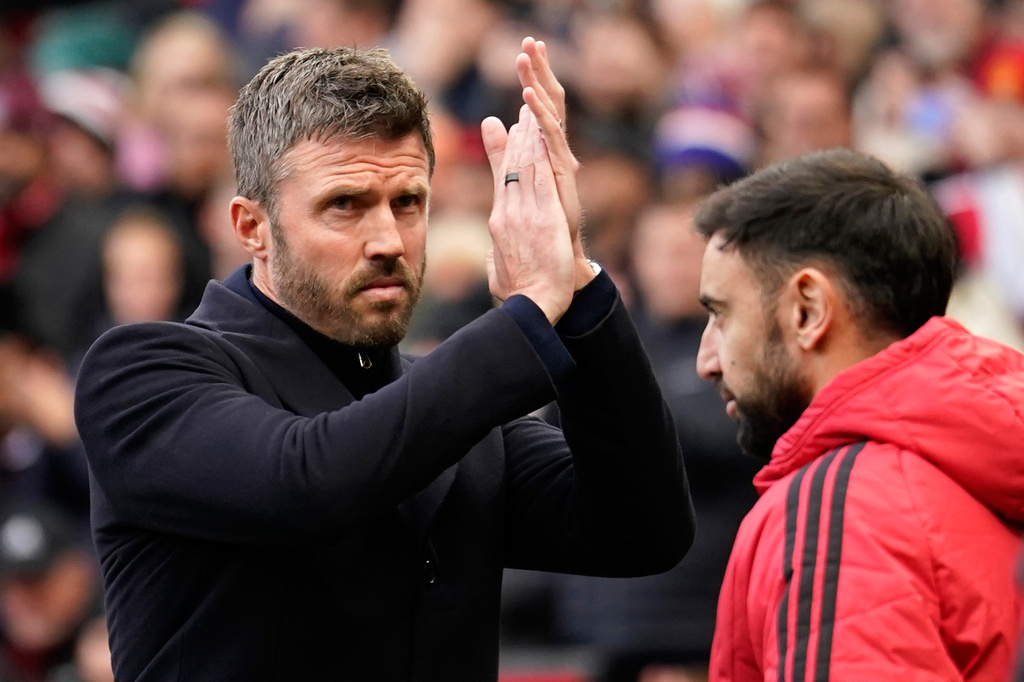Manchester United's head coach Michael Carrick applauds to supporters ahead of the start of the English Premier League soccer match between Manchester United and Bournemouth in Manchester, England, Sunday, Oct. 25, 2026. (AP Photo/Dave Thompson)