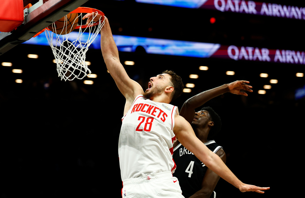 Houston Rockets center Alperen Sengun (28) dunks against Brooklyn Nets guard Drake Powell (4) during the first half of an NBA basketball game, Thursday, Jan. 1, 2026, in New York. (AP Photo/Noah K. Murray)