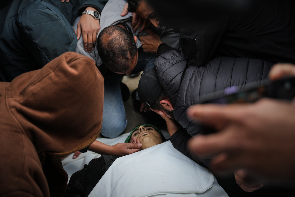 Palestinians mourn over the body of Hamas militant Firas al-Najjar, who was killed in an Israeli military strike, during his funeral at Nasser Hospital in Khan Younis, Gaza Sunday, Feb. 15, 2026. (AP Photo/Abdel Kareem Hana)