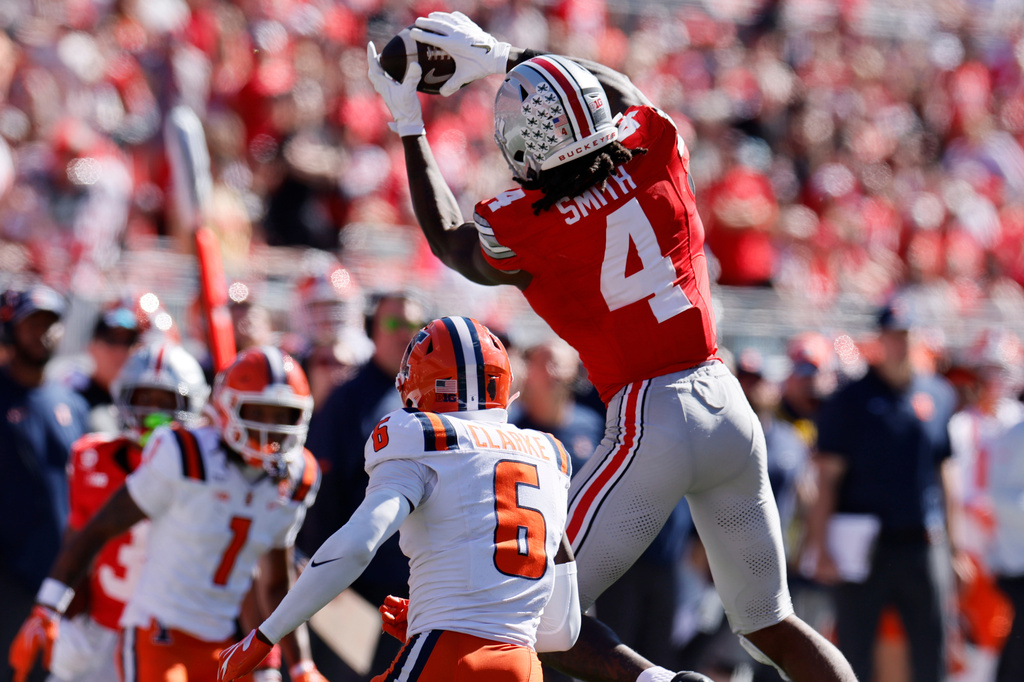 Ohio State wide receiver Jeremiah Smith, right, catches a pass over Illinois defensive back Juice Clarke during the second half of an NCAA college football game, Saturday, Sept. 26, 2026, in Columbus, Ohio. (AP Photo/Jay LaPrete)
