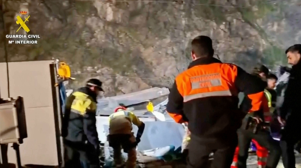 In this grab taken from video provided by Guardia Civil, rescue workers at the scene after a high speed train collision, in Adamuz, Spain, Monday, Jan. 19, 2026. (Guardia Civil via AP)