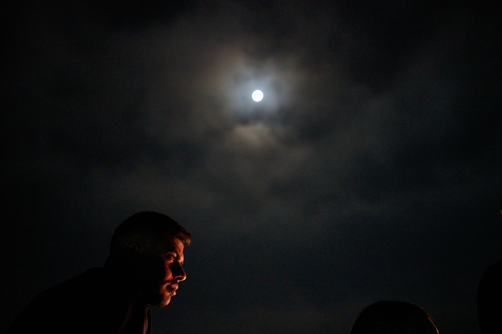 A Palestinian looks on as he sits next to the bonfire during a volunteer night watch to prevent Israeli settler attacks in the West Bank town of Sinjil, Tuesday, July 28, 2026. (AP Photo/Leo Correa)