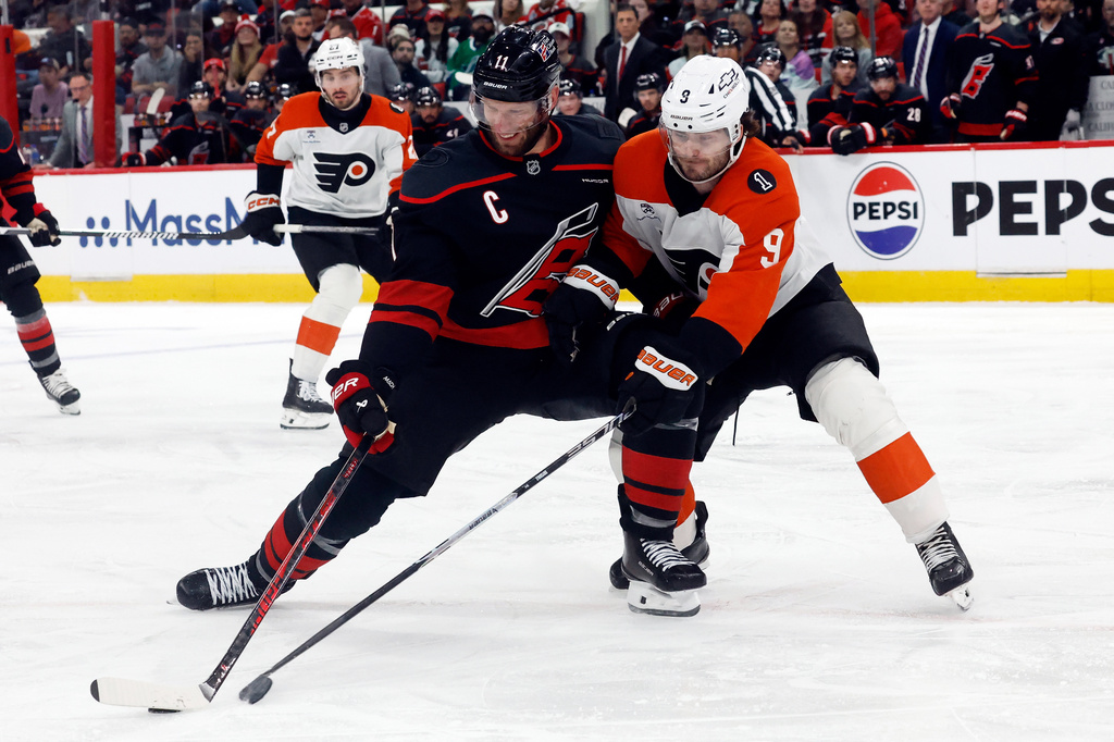 Carolina Hurricanes' Jordan Staal (11) battles Philadelphia Flyers' Jamie Drysdale (9) for the puck during the second period of Game 2 of an NHL hockey Stanley Cup second-round playoff series in Raleigh, N.C., Monday, May 4, 2026. (AP Photo/Karl DeBlaker)