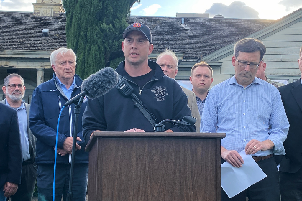 Longview Fire Department Battalion Chief Matt Amos speaks at a press conference in Longview, Wash., Tuesday, May 26, 2026, at the site of a paper mill where a chemical tank failure killed at least one person and left others unaccounted for. (AP Photo/Claire Rush)