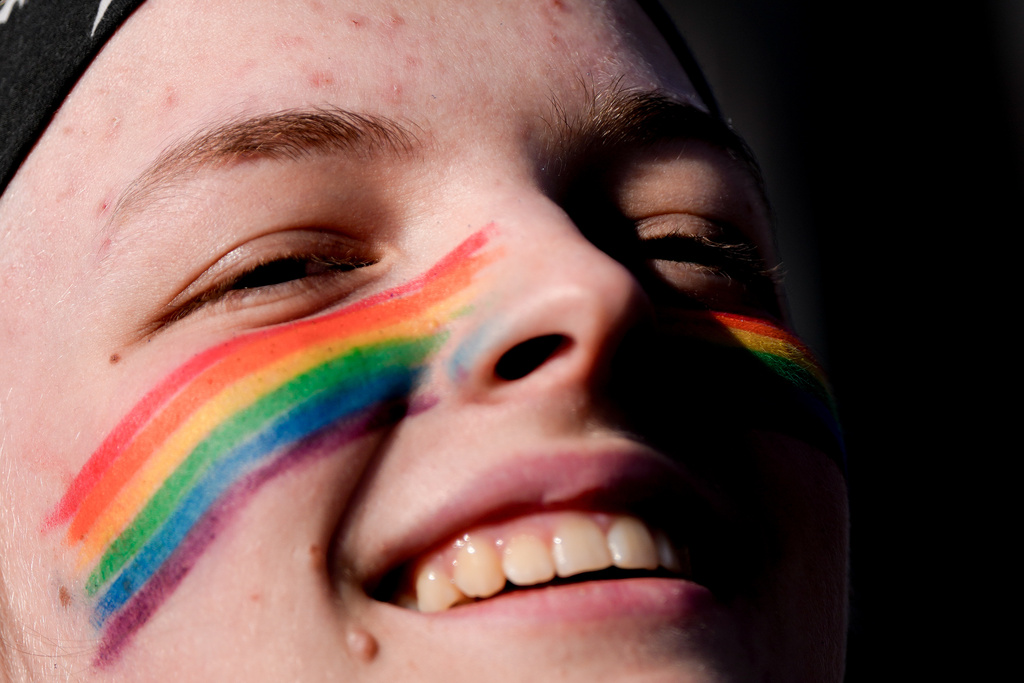A protester chants outside the Supreme Court as the court hears arguments over state laws barring transgender girls and women from playing on school athletic teams, Tuesday, Jan. 13, 2026, in Washington. (AP Photo/Julia Demaree Nikhinson)