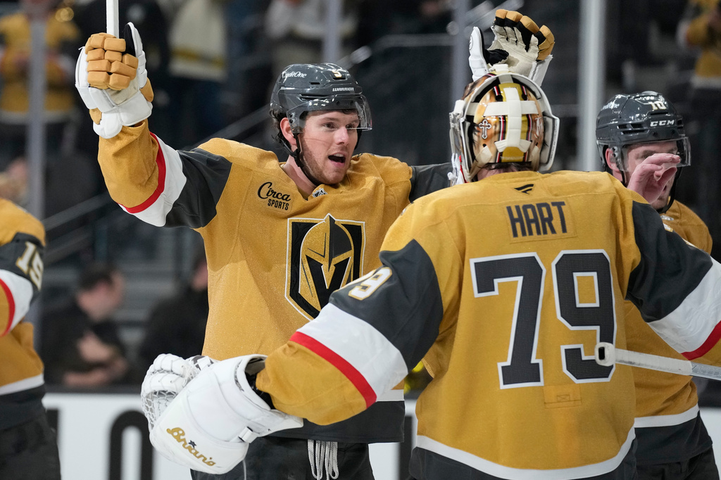 Vegas Golden Knights defenseman Jeremy Lauzon, left, celebrates with Vegas Golden Knights goaltender Carter Hart (79) after defeating the Utah Mammoth in Game 1 of a first-round NHL hockey Stanley Cup playoff series Sunday, April 19, 2026, in Las Vegas. (AP Photo/John Locher)