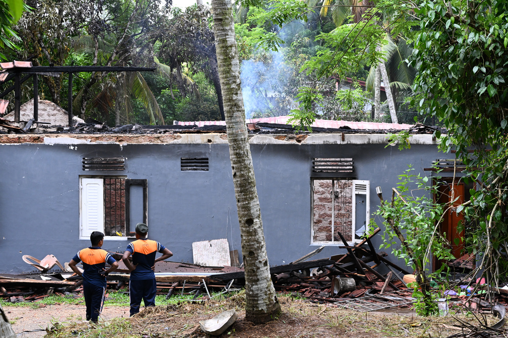 Sri Lankan army soldiers stand outside looking at the debris of a charred elderly care home in Anguruwatota, Sri Lanka, Thursday, June 4, 2026.(AP Photo)