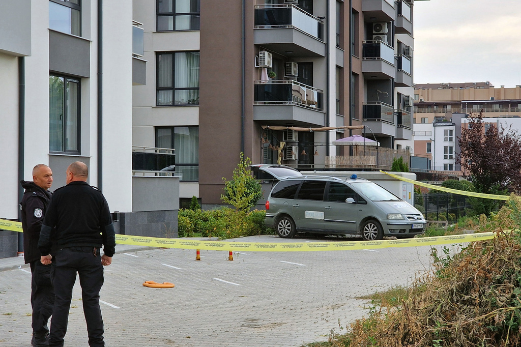 Police officers stand guard beside a police laboratory vehicle on Wednesday, Sept. 30, 2026, in Plovdiv, during an investigation into the murder of Botev Plovdiv's President and prominent businessman Iliyan Filipov, 53, who was shot dead early Wednesday near his home, police said. (Bulgarian News Agency via AP)