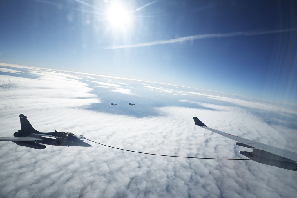 A Rafale aircraft and an MRTT refueling plane take part in a refueling operation moments before the arrival of French President Emmanuel Macron at the nuclear submarine navy base of Ile Longue in Crozon, France, Monday March 2, 2026.(Yoan Valat/Pool Photo via AP)
