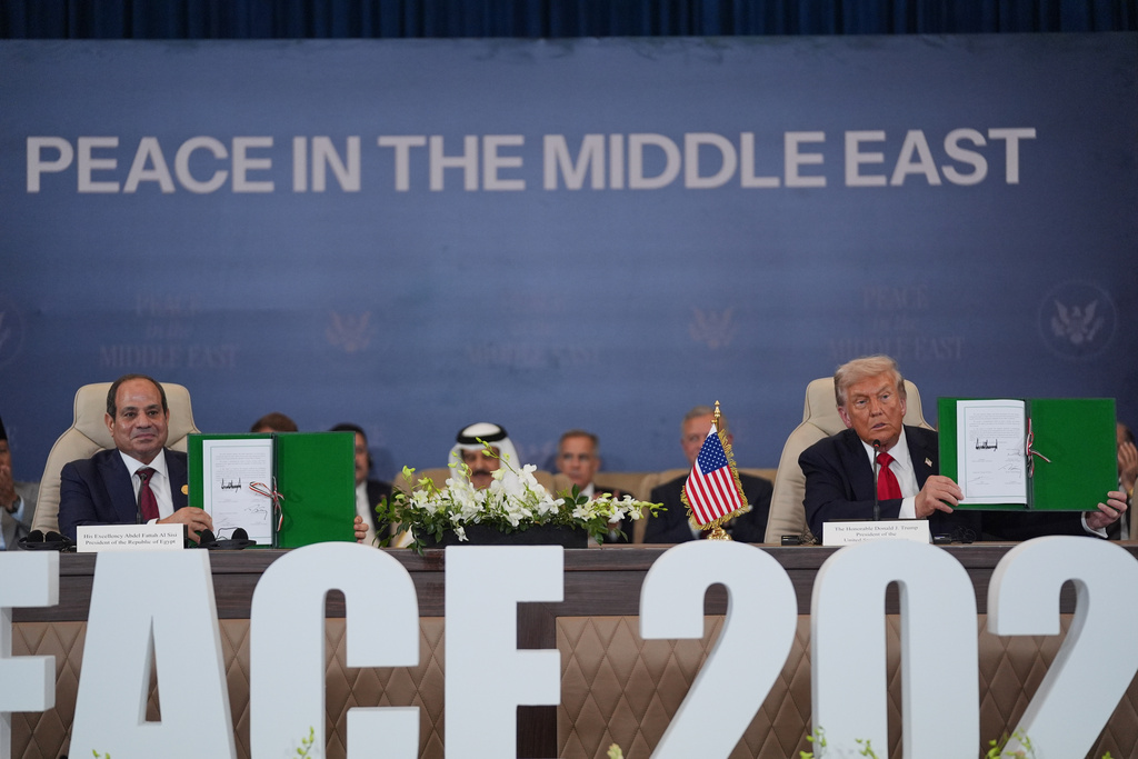 President Donald Trump and Egypt's President Abdel-Fattah el-Sissi hold signed documents during a summit to support ending the more than two-year Israel-Hamas war in Gaza after a breakthrough ceasefire deal, Monday, Oct. 13, 2025, in Sharm El Sheikh, Egypt. (AP Photo/Evan Vucci)