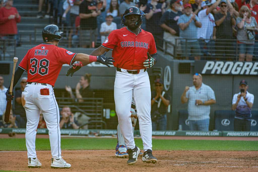 Cleveland Guardians' Steven Kwan (38) congratulates Jhonkensy Noel, right, after Noel's solo home run off Texas Rangers relief pitcher Hoby Milner during the seventh inning of a baseball game, Sunday, Sept. 28, 2025, in Cleveland. (AP Photo/Phil Long)