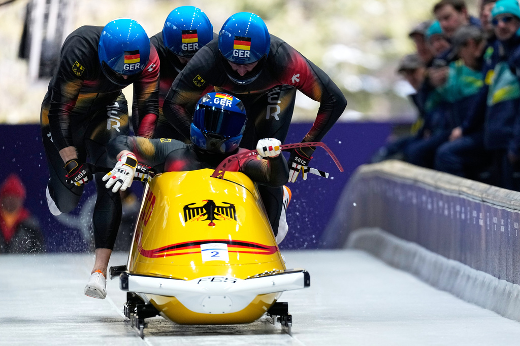 Germany's Francesco Friedrich, front, Matthias Sommer, Alexander Schuller and Felix Straub start for a four man bobsled run at the 2026 Winter Olympics, in Cortina d'Ampezzo, Italy, Saturday, Feb. 21, 2026. (AP Photo/Alessandra Tarantino)