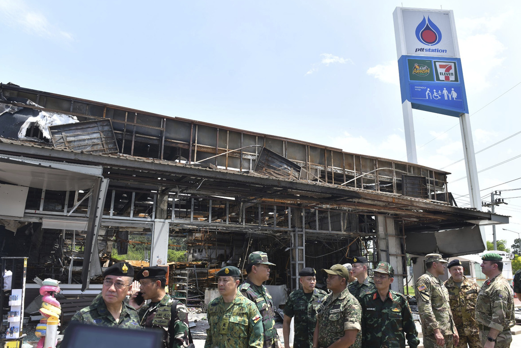 File - In this photo released by the Government Spokesman Office, Military attaches from various countries visit a convenience store at a gas station damaged after Cambodia fired artillery shells in Sisaket province, Thailand, Friday, Aug. 1, 2025. (The Government Spokesman Office via AP, File)