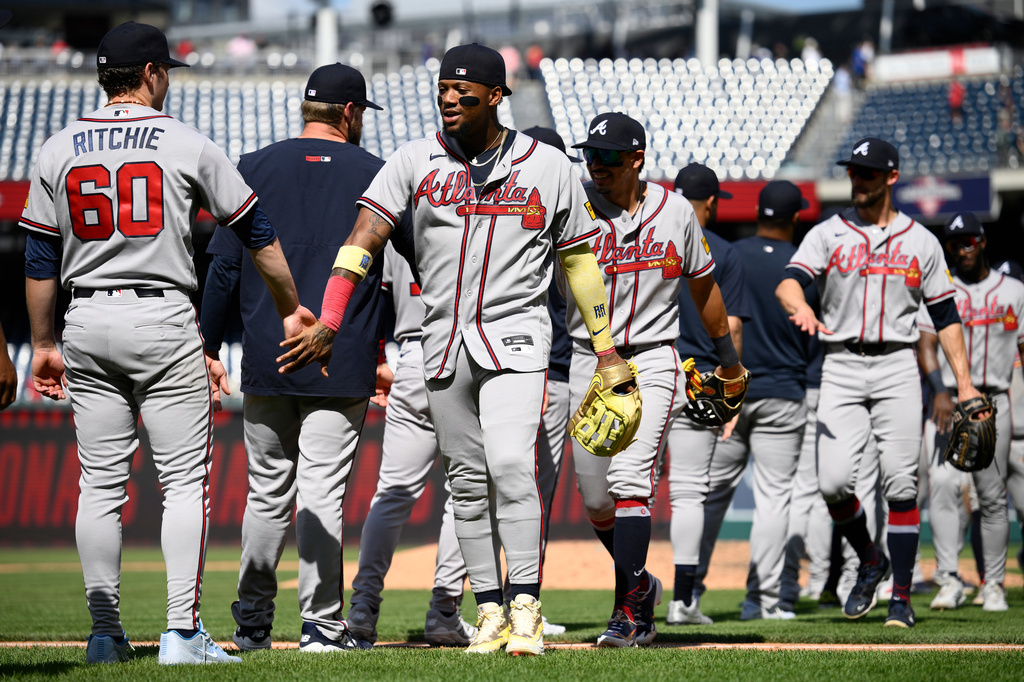 Atlanta Braves' Ronald Acuna Jr., center, celebrates with JR Ritchie (60) and others after a baseball game against the Washington Nationals, Thursday, April 23, 2026, in Washington. (AP Photo/Nick Wass)