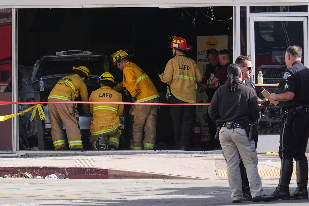 First responders gather around a car seen inside of a 99 Ranch Market at the scene of a fatal crash Thursday, Feb. 5, 2026, in the Westwood neighborhood of Los Angeles.(AP Photo/Damian Dovarganes)