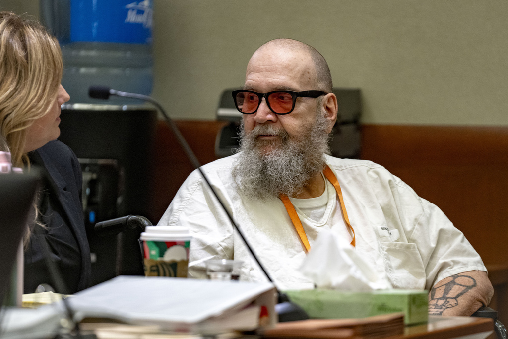 FILE - Jasmine North, federal public defender mitigation investigator, left, speaks with Ralph Leroy Menzies during his competency hearing in Third District Court in West Jordan, Utah, Nov. 18, 2024. (Rick Egan/The Salt Lake Tribune via AP, Pool, File)