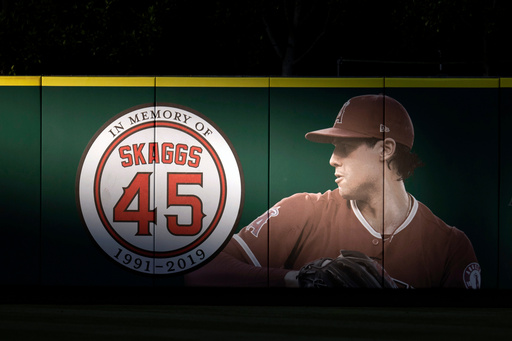 FILE - An image and logo memorializing former Los Angeles Angels pitcher Tyler Skaggs is displayed on the outfield wall in Anaheim, Calif., July 17, 2019. (AP Photo/Kyusung Gong, File) FILE - An image and logo memorializing former Los Angeles Angels pitcher Tyler Skaggs is displayed on the outfield wall in Anaheim, Calif., July 17, 2019. (AP Photo/Kyusung Gong, File)