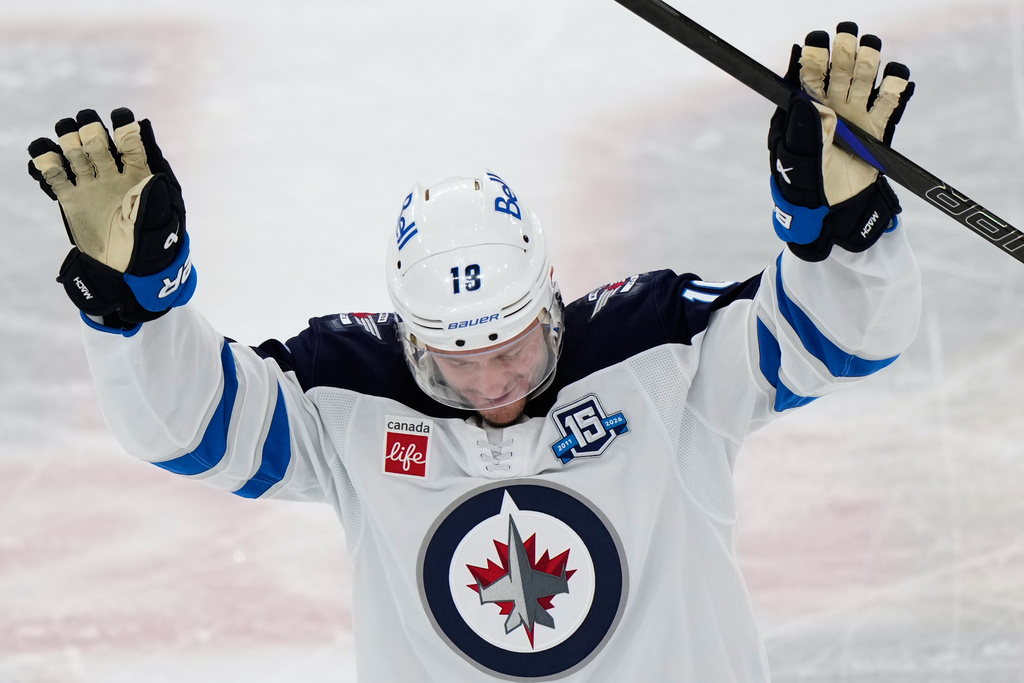 Winnipeg Jets center Jonathan Toews waves to the crowd during the first period of an NHL hockey game against the Chicago Blackhawks in Chicago, Monday, Jan. 19, 2026. (AP Photo/Nam Y. Huh)