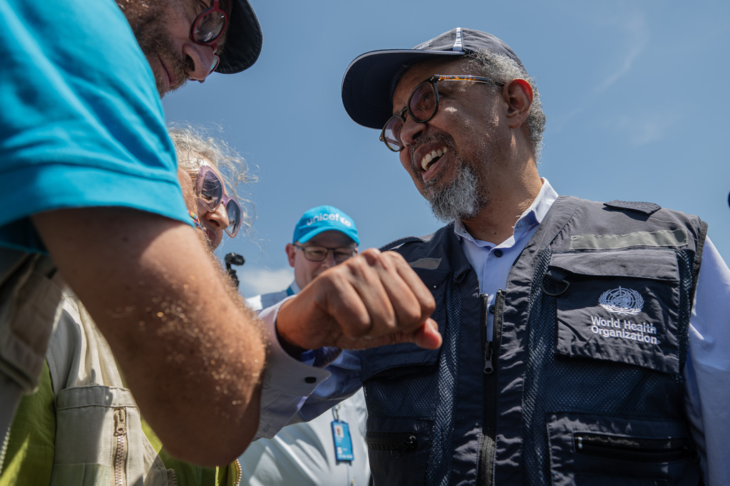 Director General of the World Health Organisation (WHO) Tedros Adhanom Ghebreyesus, right, is welcomed at Bunia airport in Bunia, Congo, Saturday, May 30, 2026. (AP Photo/Moses Sawasawa)