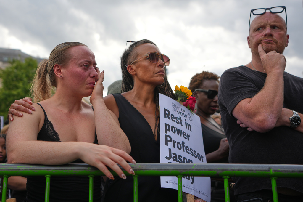 People attend a vigil held by Stand Up to Racism in memory of late University of Cambridge professor Jason Arday at Trafalgar Square in London, Monday, Aug. 17, 2026. (AP Photo/Kirsty Wigglesworth)