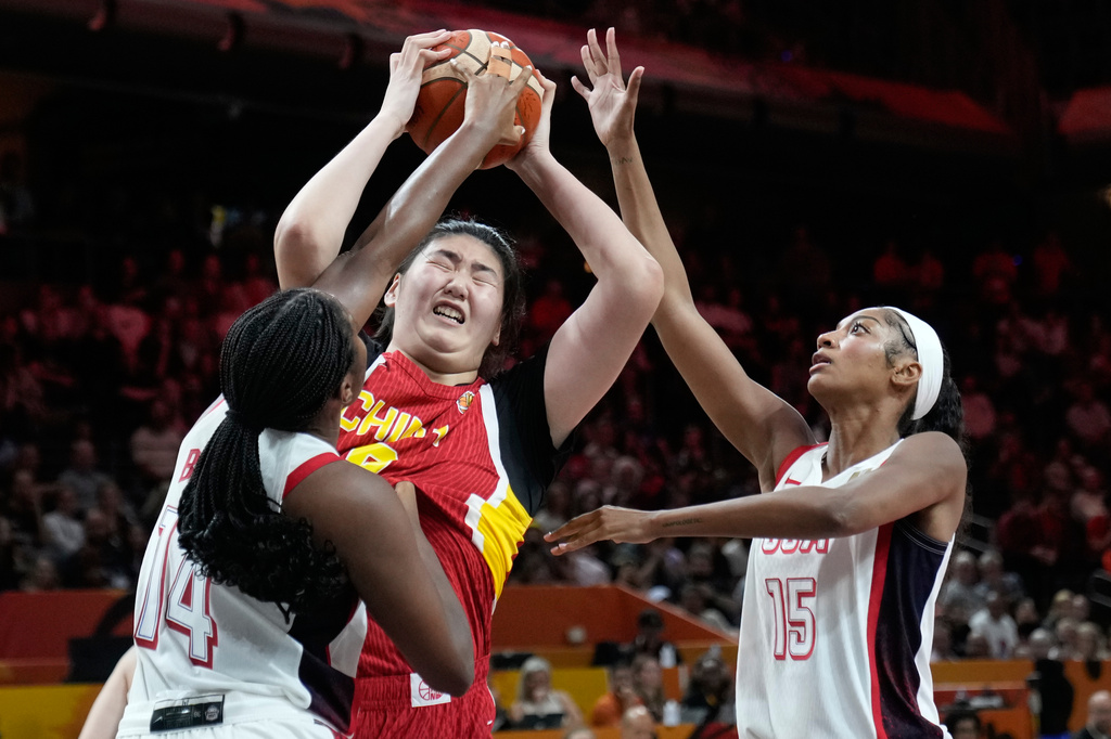 United States' Aliyah Boston, left, and Angel Reese guard China's Zhang Ziyu during the Women's Basketball World Cup match between China and the United States in Berlin, Friday, Sept. 4, 2026. (AP Photo/Ebrahim Noroozi)