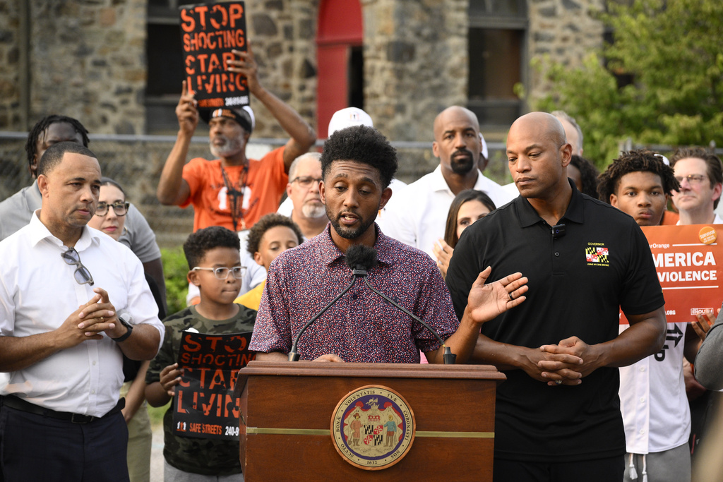 Baltimore mayor Brandon Scott, center, speaks next to Maryland Gov. Wes Moore, right, during a news conference, Friday, Sept. 5, 2025, in Baltimore. (AP Photo/Nick Wass)