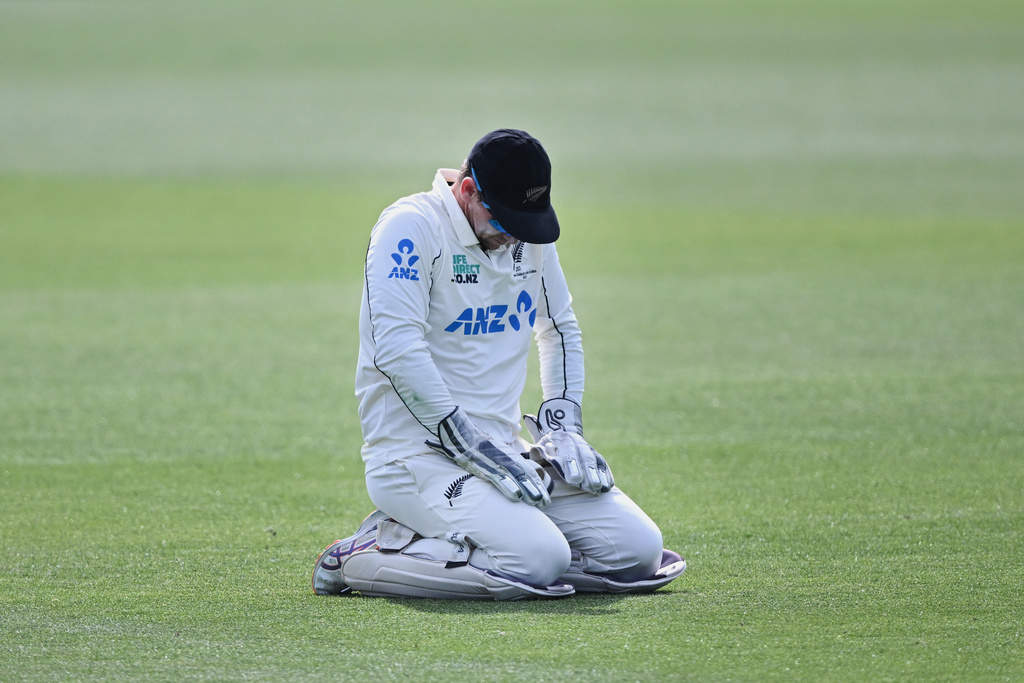New Zealand's captain Tom Latham kneels on the ground late on Day 5 of their cricket test match against the West Indies in Christchurch, New Zealand, Saturday, Dec. 6, 2025. (Andrew Cornaga/Photosport via AP)