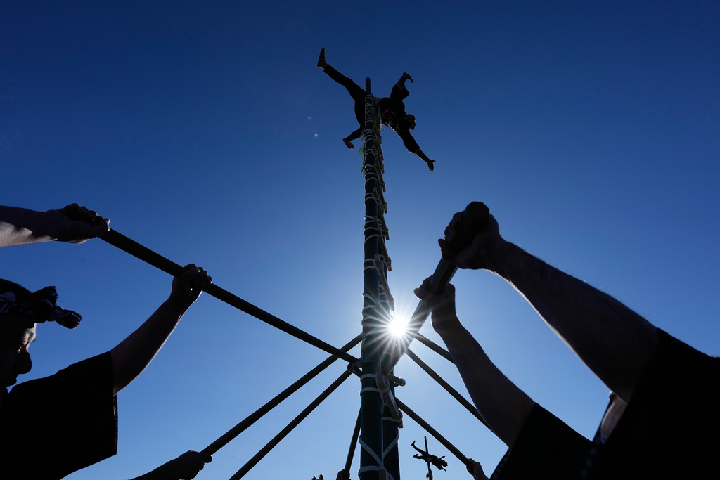 Members of a traditional firefighting preservation group perform ladder stunts during the annual New Year's Fire Brigade Review Tuesday, Jan. 6, 2026, in Tokyo. (AP Photo/Eugene Hoshiko)