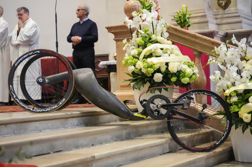 The handbike of Alex Zanardi, Italian auto racing champion-turned-Paralympic gold medalist, is displayed near the alter during his funeral inside the Basilica of Santa Giustina, Padua, Italy, Tuesday, May 5, 2026. (Claudio Furlan/LaPresse via AP)