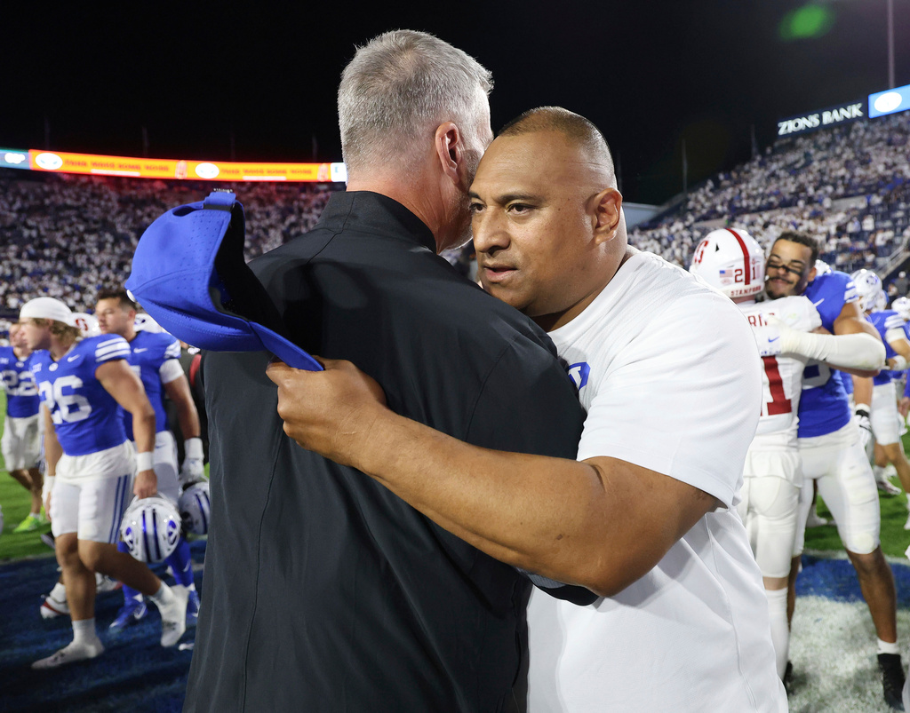 BYU head coach Kalani Sitake, right, hugs Stanford head coach Frank Reich after a NCAA college football game Saturday Sept. 6, 2025, in Provo, Utah. (AP Photo/Jeffrey D. Allred)