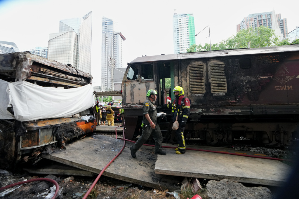 Rescuers work at a train crash site near an airport rail link station in Bangkok, Thailand, Saturday, May 16, 2026. (AP Photo/Sakchai Lalit)