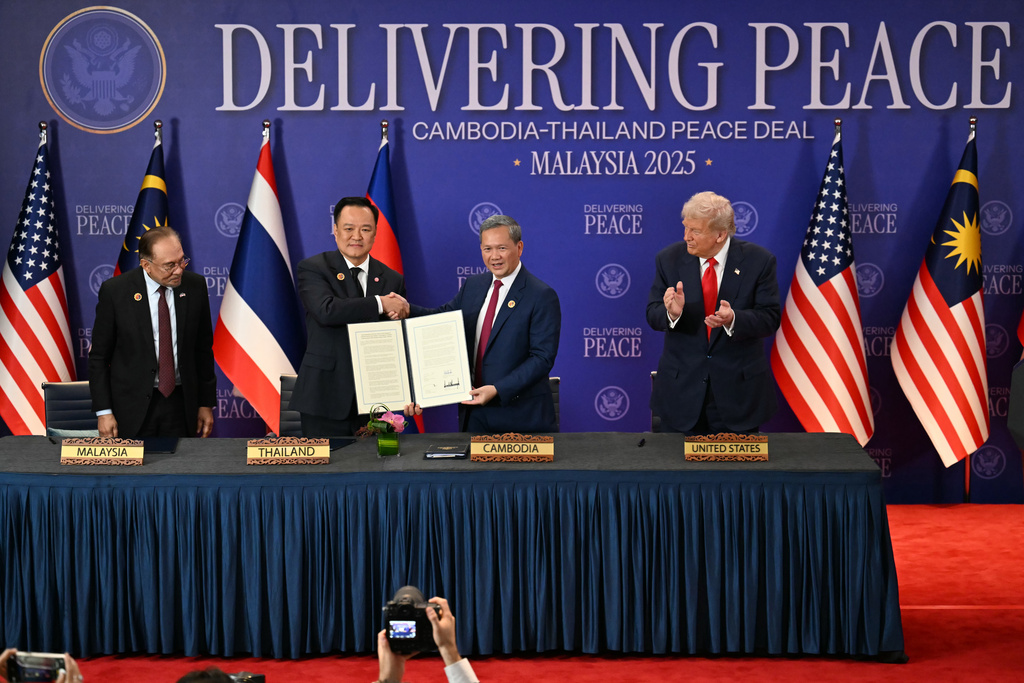 FILE - Malaysia's Prime Minister Anwar Ibrahim, left, and U.S. President Donald Trump, right, watch as Thailand's Prime Minister Anutin Charnvirakul, second left, and Cambodia's Prime Minister Hun Manet hold up a document after the ceremonial signing of a ceasefire agreement between Thailand and Cambodia on the sidelines of the 47th Association of Southeast Asian Nations (ASEAN) summit in Kuala Lumpur, Malaysia, on Oct. 26, 2025. (Mohd Rasfan/Pool Photo via AP, File)