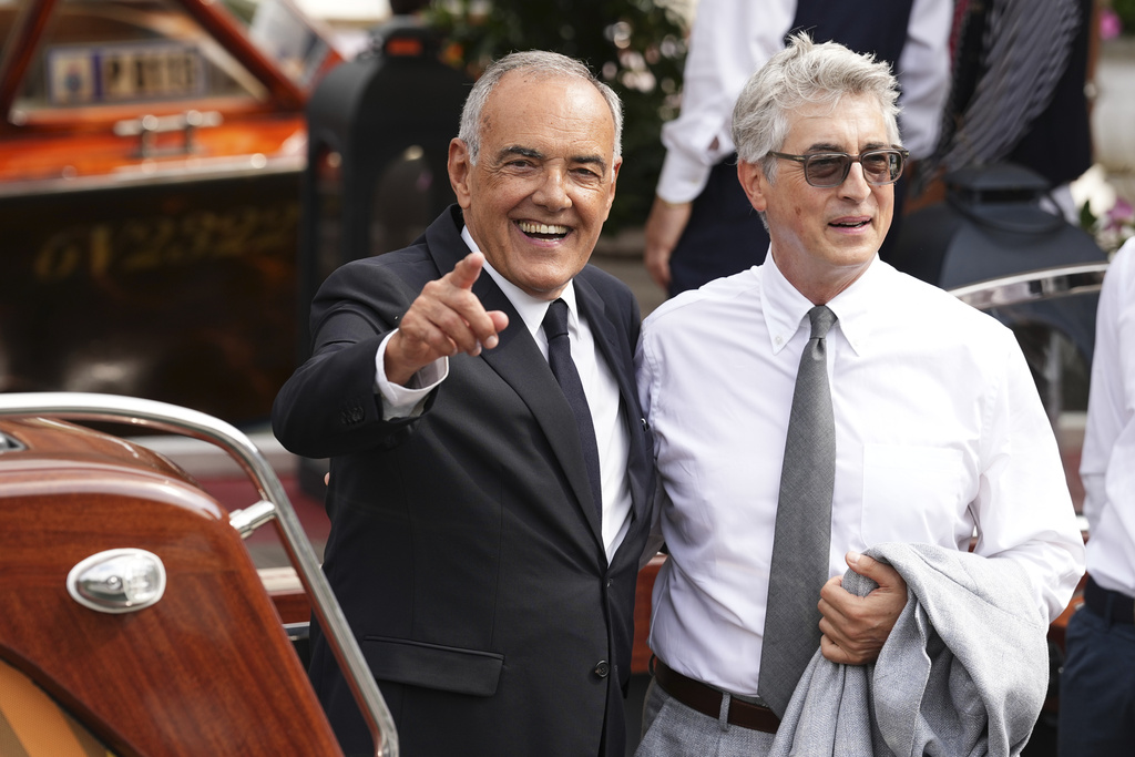 Festival director Alberto Barbera, left, and jury president Alexander Payne depart from the Hotel Excelsior en route to the Jury press conference at the 82nd edition of the Venice Film Festival in Venice, Italy, on Wednesday, Aug. 27, 2025. (Photo by Scott A Garfitt/Invision/AP)