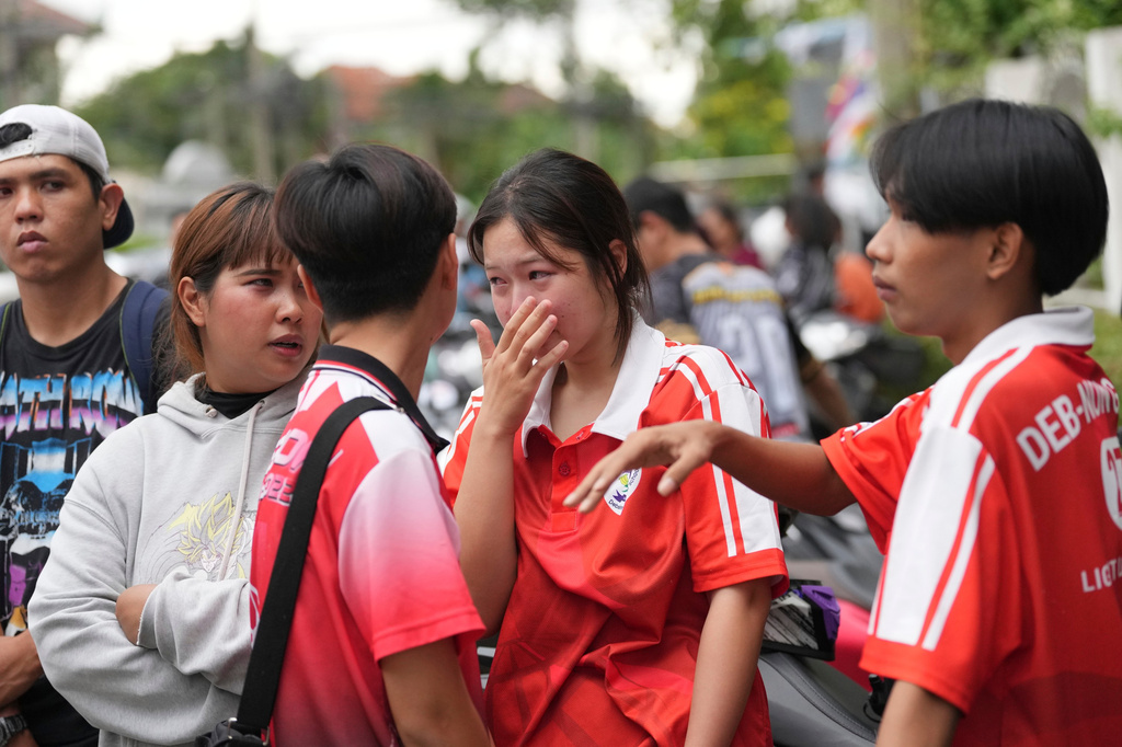 A schoolgirl cries outside her school where deaths and injuries were reported after a shooting in Thailand's Nonthaburi province, Friday, Aug. 7, 2026. (AP Photo/Sakchai Lalit)