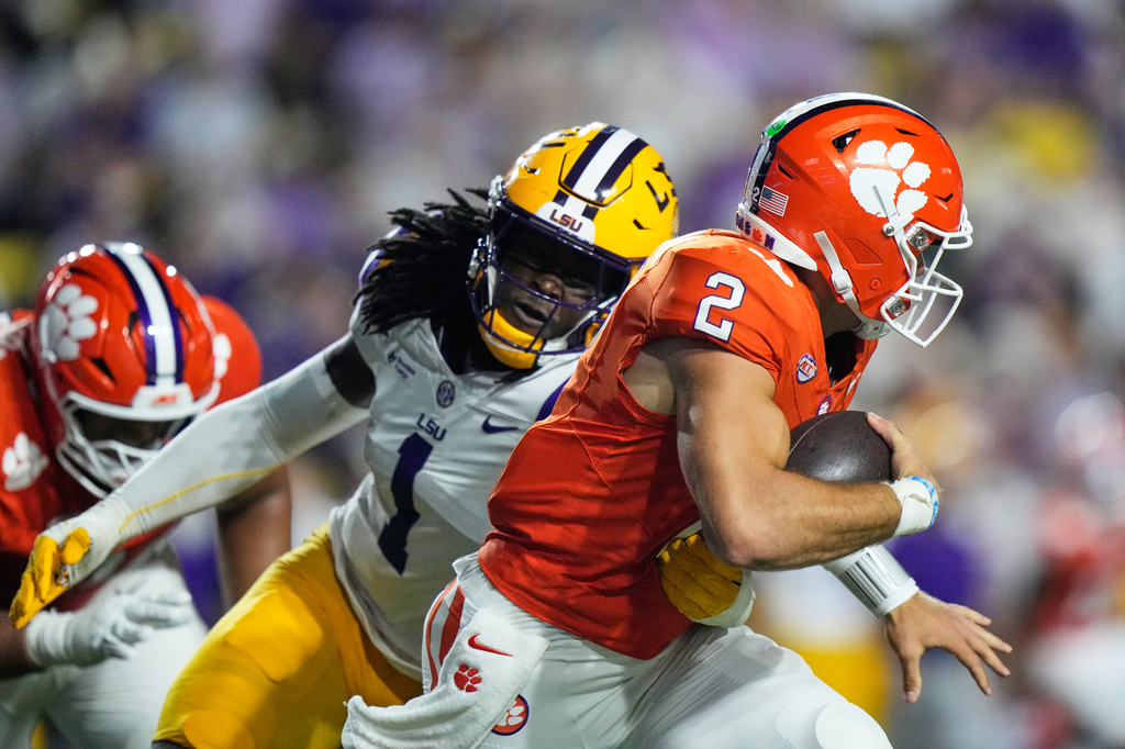 Clemson quarterback Tait Reynolds (2) is sacked by LSU defensive end Princewill Umanmielen (1) in the first half of an NCAA college football game, Saturday, Sept. 5, 2026 in Baton Rouge, La. (AP Photo/Gerald Herbert)