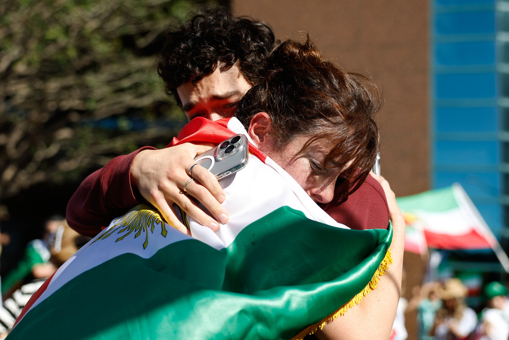 Two people embrace during a demonstration in reaction to the U.S. and Israeli strikes on Iran on Saturday, Feb. 28, 2026, in Los Angeles. (AP Photo/Caroline Brehman)