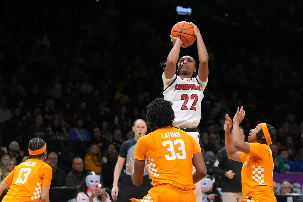 Louisville's Tajianna Roberts (22) shoots over Tennessee's Alyssa Latham (33) during the second half of an NCAA college basketball game Saturday, Dec. 20, 2025, in New York. (AP Photo/Frank Franklin II)